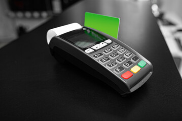 Bank terminal and payment card in the office interior.
