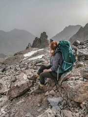 Woman hiking the long distance hike in Corsica called the GR20. A long hike with a heavy backpack....