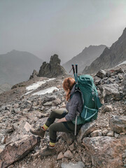 Woman hiking the long distance hike in Corsica called the GR20. A long hike with a heavy backpack....