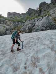 Woman hiking the long distance hike in Corsica called the GR20. A long hike with a heavy backpack....
