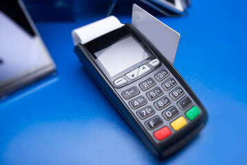 Obraz premium Bank terminal and payment card in the office interior.