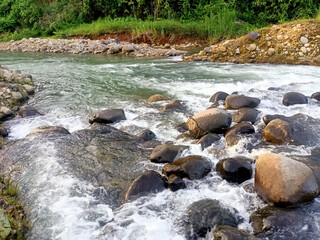 water flowing over rocks river clean