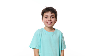 Emotional portrait of lovely Caucasian teen boy, smiling looking at camera, isolated on white...