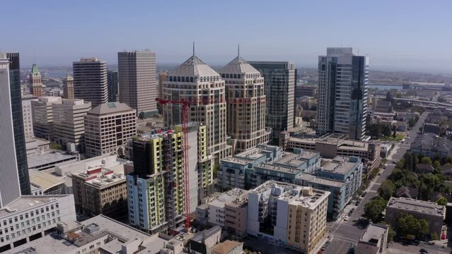 Afternoon skyline aerial view of the urban core of downtown Oakland, California, USA.