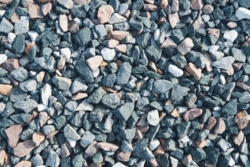 Mix gravel background. Angular stones of different colors.