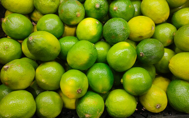 yellow green lime fruits on the counter of the grocery market