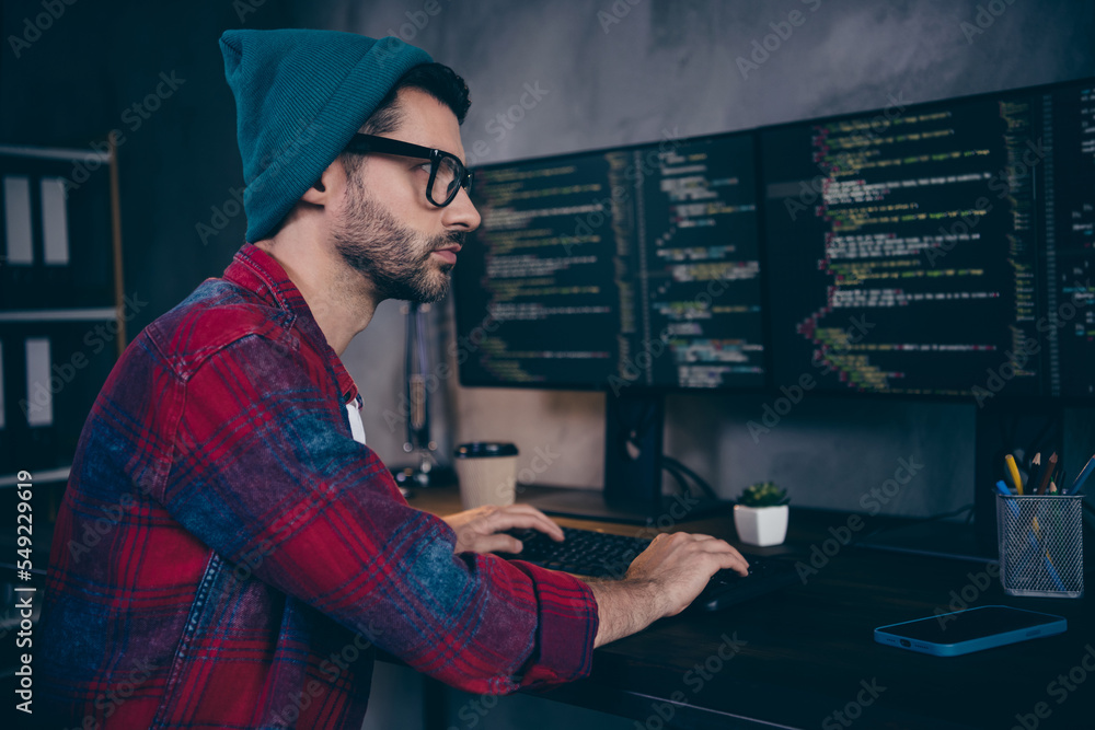 Poster photo of clever cool coder dressed hat glasses creating program modern gadget indoors workplace work
