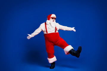 Full length body size view of his he attractive cheerful funny fat white-haired Santa dancing...