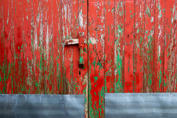 detail of an old and antique wooden door painted green