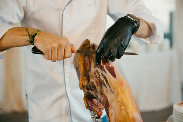close up view of a professional ham cutter while cutting the ham and preparing the portions