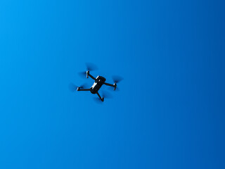 blue sky and a flying drone