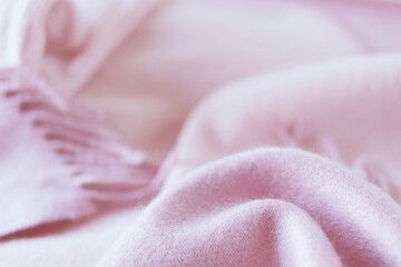 Cashmere texture, natural wool, pink cashmere clothes folded on the table, fabric background, top view, concept of warmth and winter comfort - obrazy, fototapety, plakaty