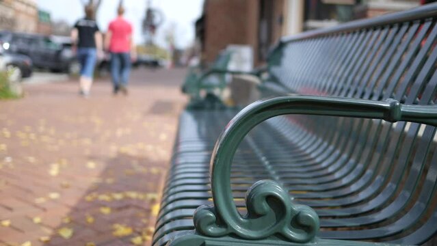 A bench situated in small American town during fall