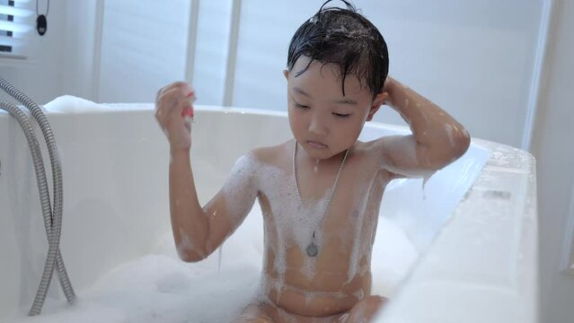 child taking a bath in the bathtub