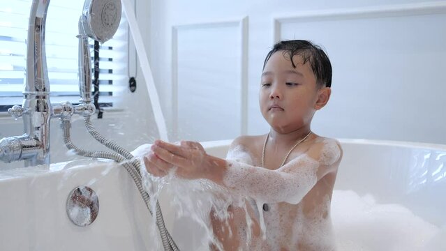 child taking a bath in the bathtub
