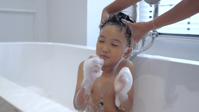 child taking a bath in the bathtub