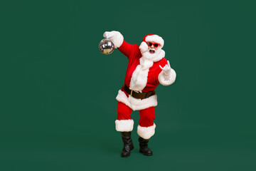 Full body photo crazy santa claus with grey beard hold disco ball show horns symbol dance x-mas...