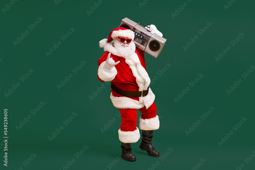 Sticker Full size photo of grey white hair bearded santa claus show horned symbol hold boom box on x-mas christmas party wear headwear cap isolated bright shine color background