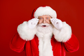 Portrait astonished santa claus impressed x-mas newyear christmas magic miracle advent sales discount touch white gloves specs wear red headwear isolated bright shine color background