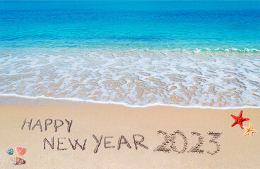 happy new year 2023 written on the shore