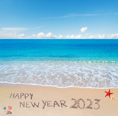 happy new year 2023 written in the sand
