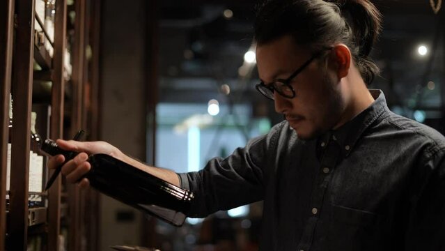 Night club concept of 4k Resolution. The bartender is checking the merchandise in the store. A group of specialized clubs that sell alcoholic beverages.