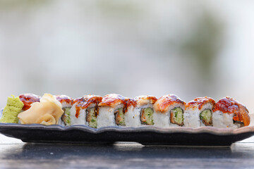 Sushi is a Japanese dish of prepared vinegared rice, usually with some sugar and salt, accompanied by a variety of ingredients.