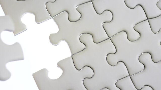 Hand holding jigsaw puzzle last missing piece lighting. 
Concept last piece of jigsaw puzzle for problem and 
completion.