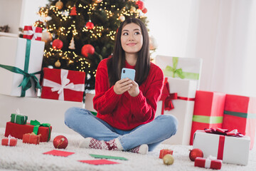 Photo of dreamy sweet girl wear xmas red pullover typing wishes twitter telegram facebook indoors home room