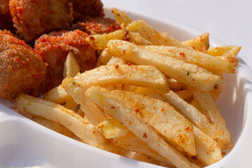 French fries on a white plate on a white background