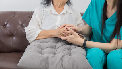 Caregiver with Asian elderly woman indoor