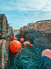 Lobster pots and crab pots with ropes and floats on the quayside at Mudeford, Christchurch in Dorset, UK - obrazy, fototapety, plakaty
