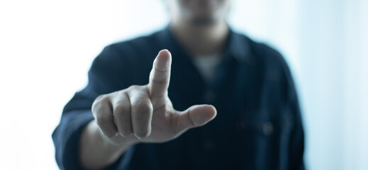 Man on blurred background pointing his finger