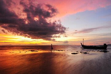a fishing boat on the beach at dusk