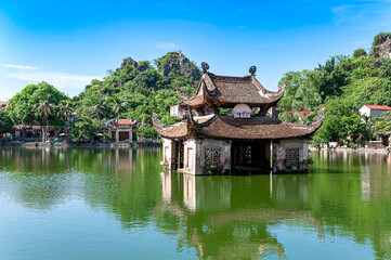 Fototapeta na wymiar An ancient water puppet stage in a lake in front of Thay Pagoda in Hatay district of Hanoi. Thay Pagoda is one of the most famous pagodas in Hanoi and was built in the 1072s.