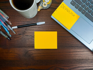 Flat lay, a mockup of a notebook. A workspace with white notebooks, laptops, office supplies, pencils, and coffee cups in the office background of a wooden desk from top view.