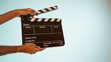 Hand is holding clapper board or clapperboard or movie slate, used in film production and cinema...