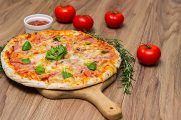 Italian pizza Capricciosa  with cheese, tomato sauce and basil