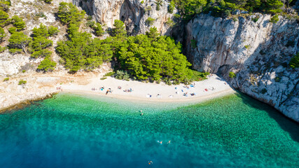 Fototapeta na wymiar Croatia. Aerial view on beach and people. Vacation and relax. Beach and blue water. Top view from drone at beach and azure sea. Travel and holiday