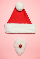 Creative minimalistic image of the Christmas theme. Santa Claus hat and beard.