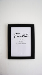 A photo of a frame that reads a bible verse in Matthew 17:20 about faith to God, that can move mountains.