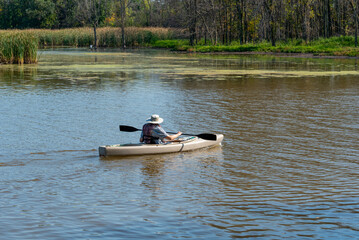 A Person Paddling A Kayak On The River