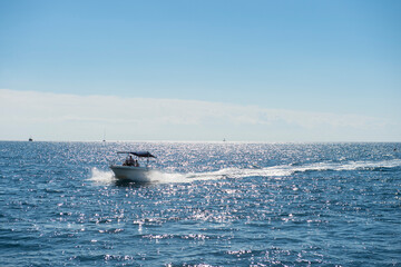 Fototapeta premium A view of the Adriatic Sea with a speedboat and a beautiful sky
