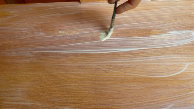 Priming and painting the wooden board. Vertical Video.