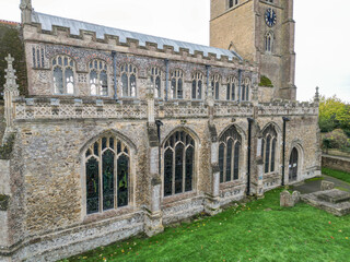 Fototapeta premium Architectural view of a large parish church showing the detailed windows and clock tower.