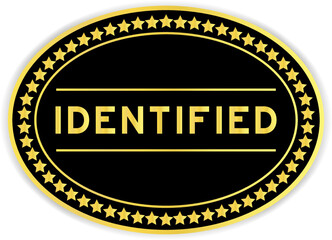 Gold and black color oval label sticker with word identified on white background