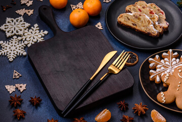 Delicious festive New Year's pie with candied fruits, marzipan and nuts on a dark concrete background
