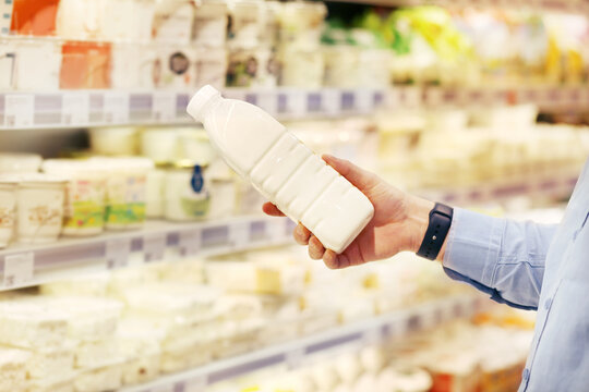 man choosing a dairy products at supermarket.