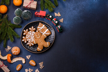 Delicious festive New Year's pie with candied fruits, marzipan and nuts on a dark concrete background