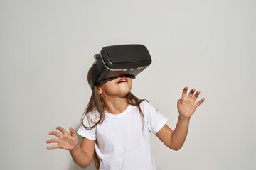 Little girl of zoomer generation using VR headset